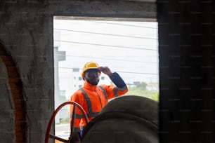 a man in an orange safety vest and hard hat