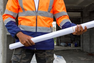 a construction worker holding a large piece of paper