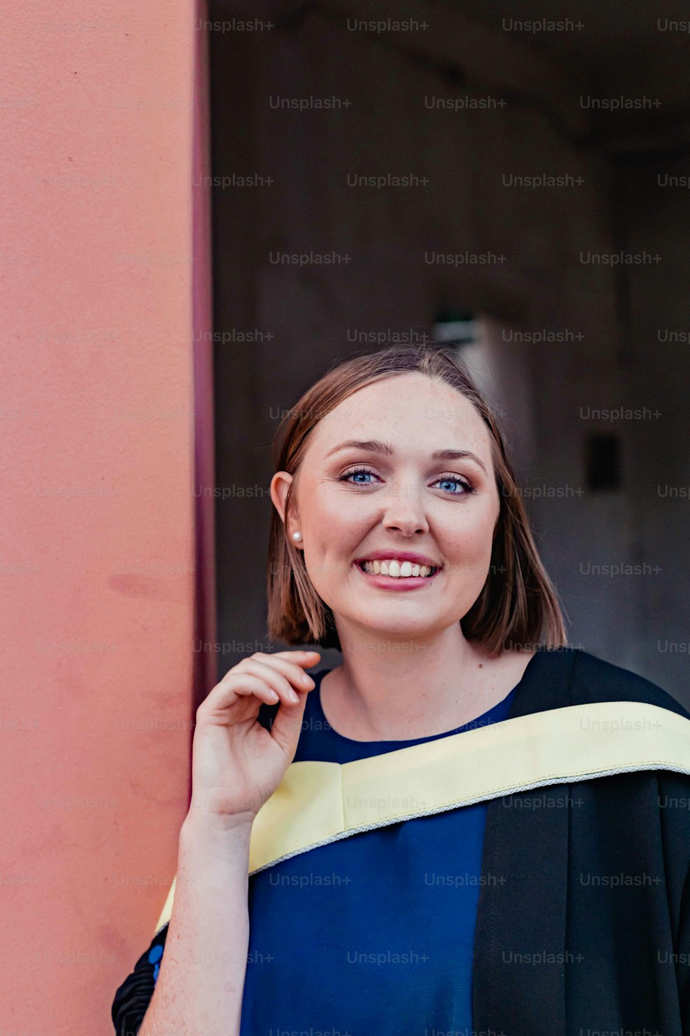 a woman in a graduation gown posing for a picture