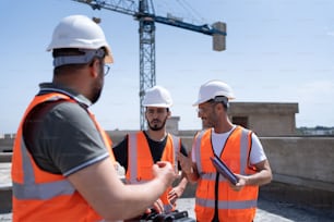 a group of construction workers talking to each other