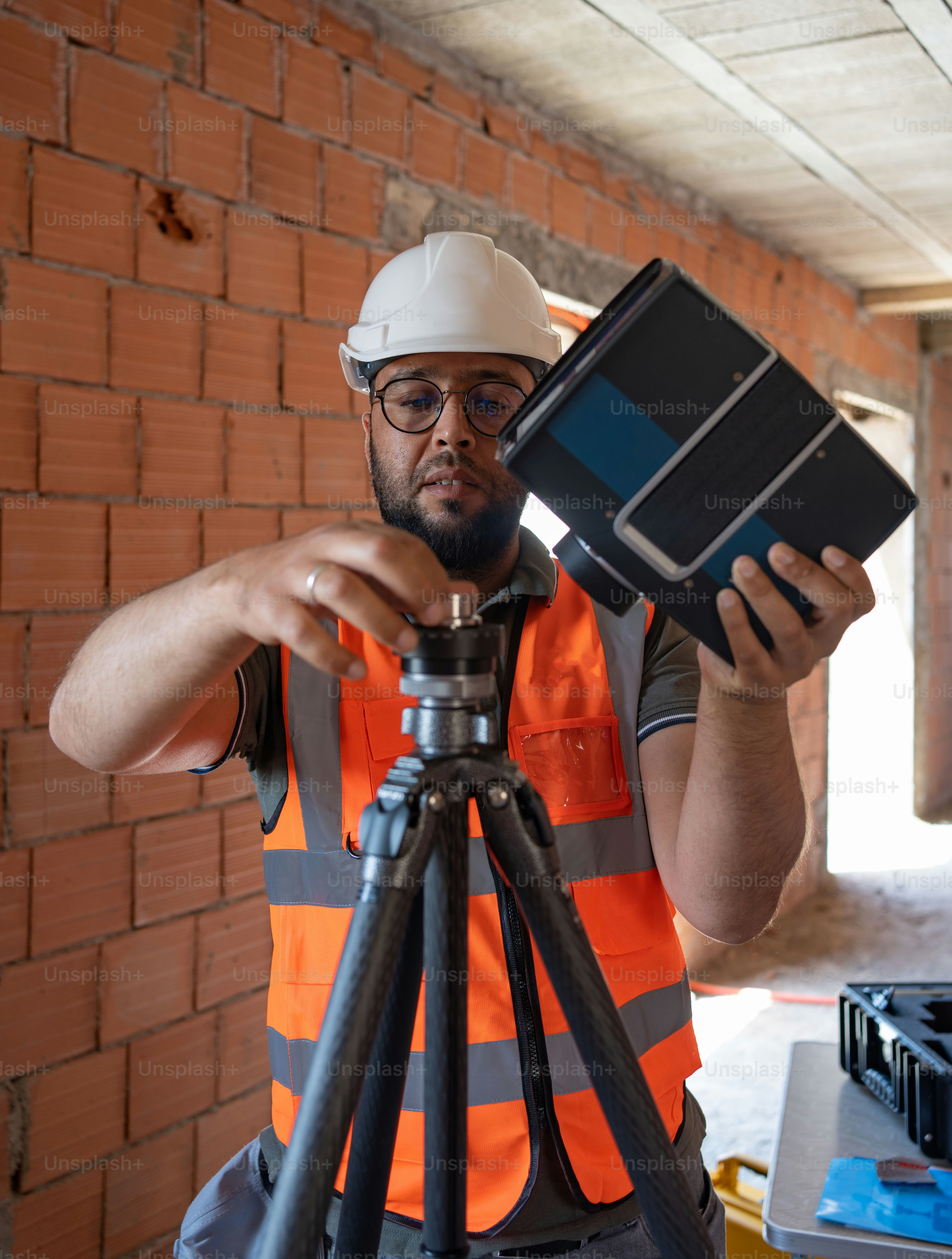 A man in a hard hat holding a camera photo – Engineer Image on Unsplash