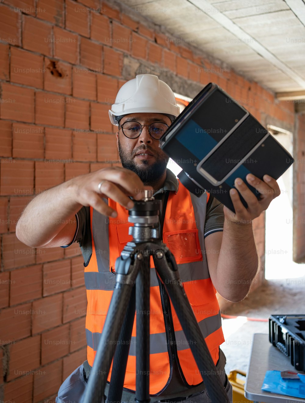 a man in a hard hat holding a camera