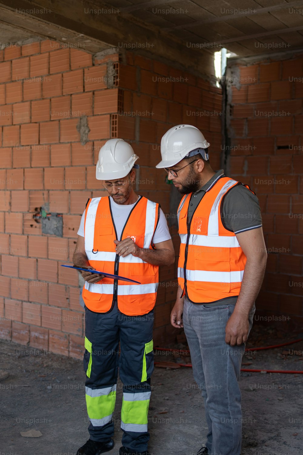 two construction workers standing next to each other