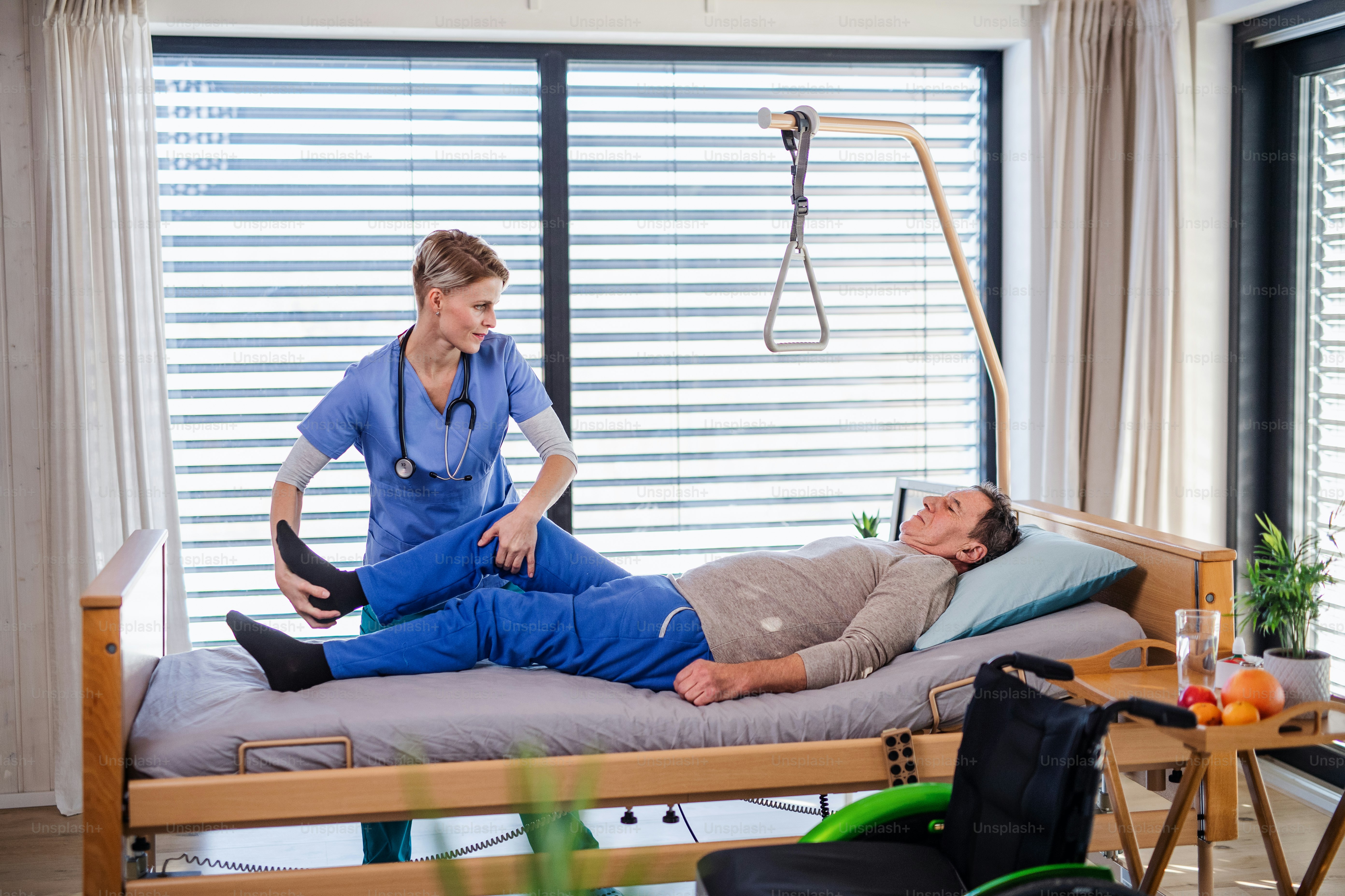 A healthcare worker and senior patient in hospital, physiotherapy concept