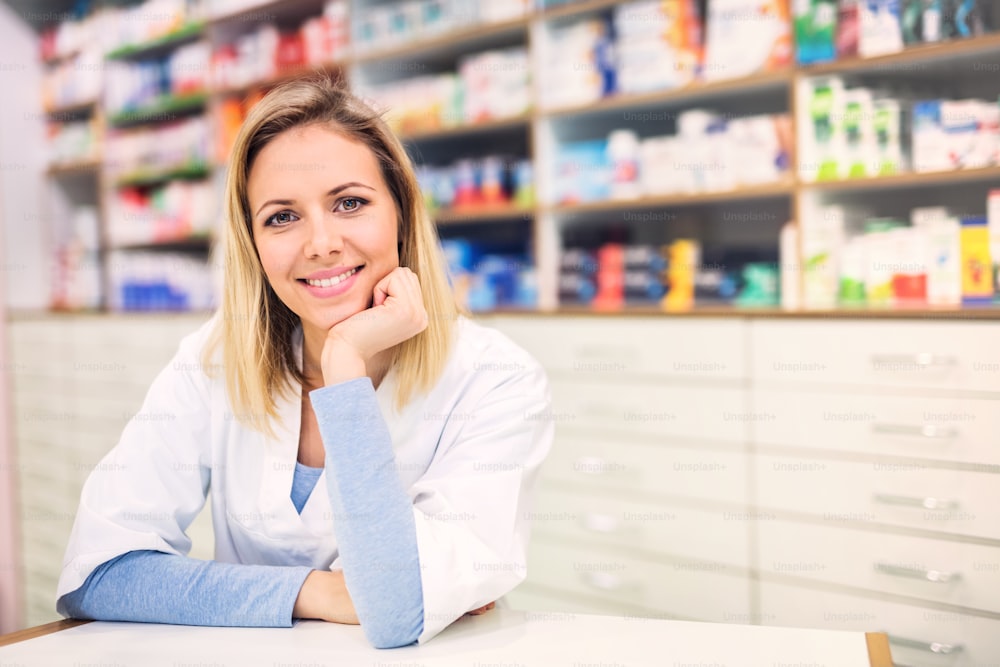 Portrait of a young beautiful friendly female pharmacist. Copy space.