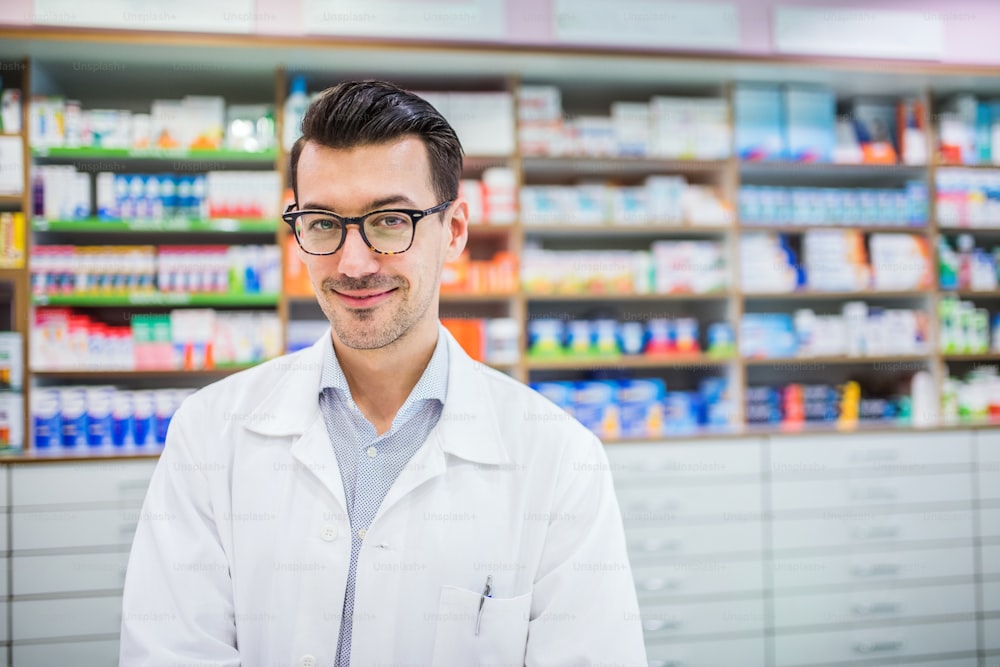 Portrait of a young atrractive friendly male pharmacist.
