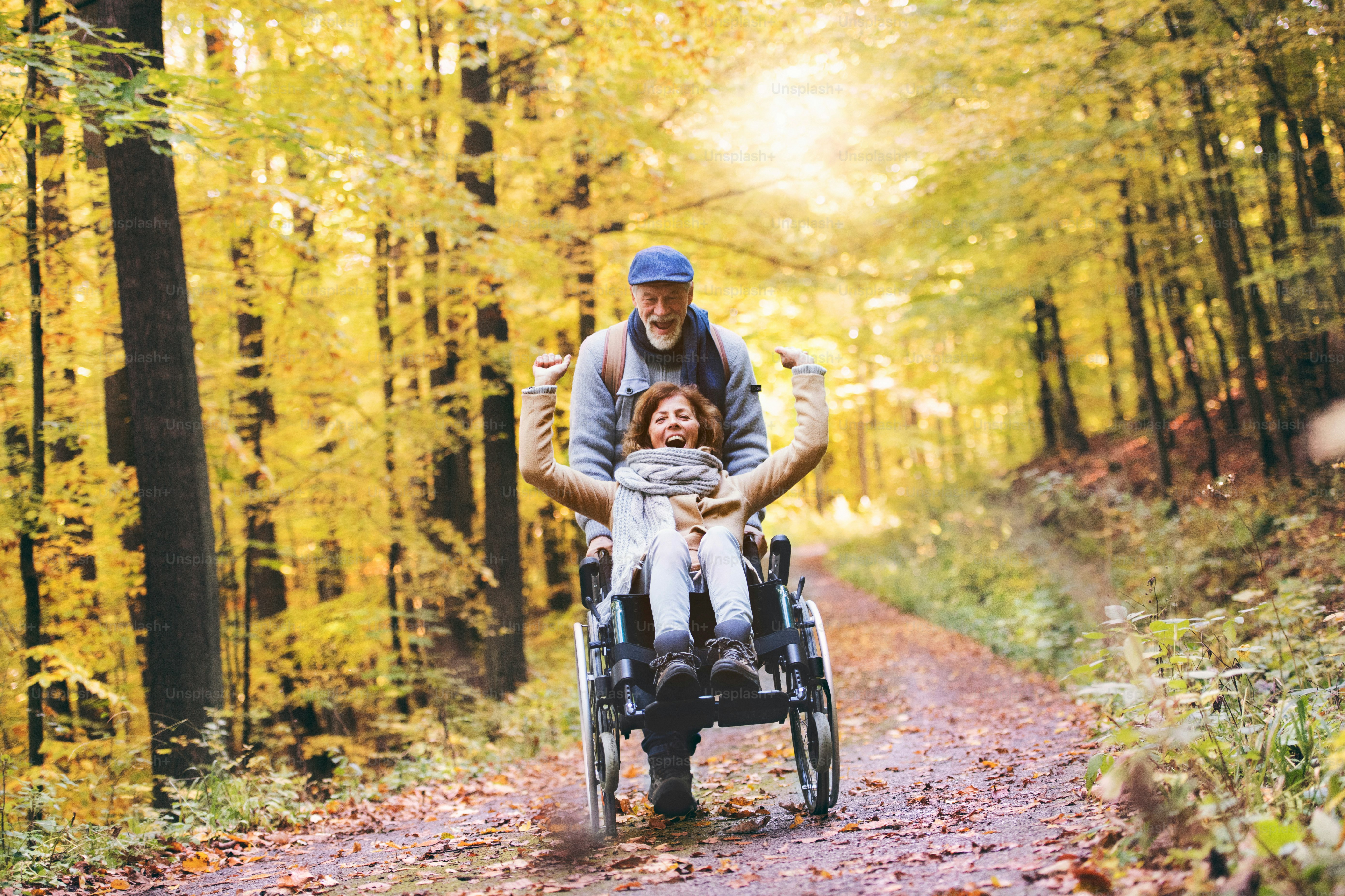Active senior couple on a walk in a beautiful autumn nature. A woman ...