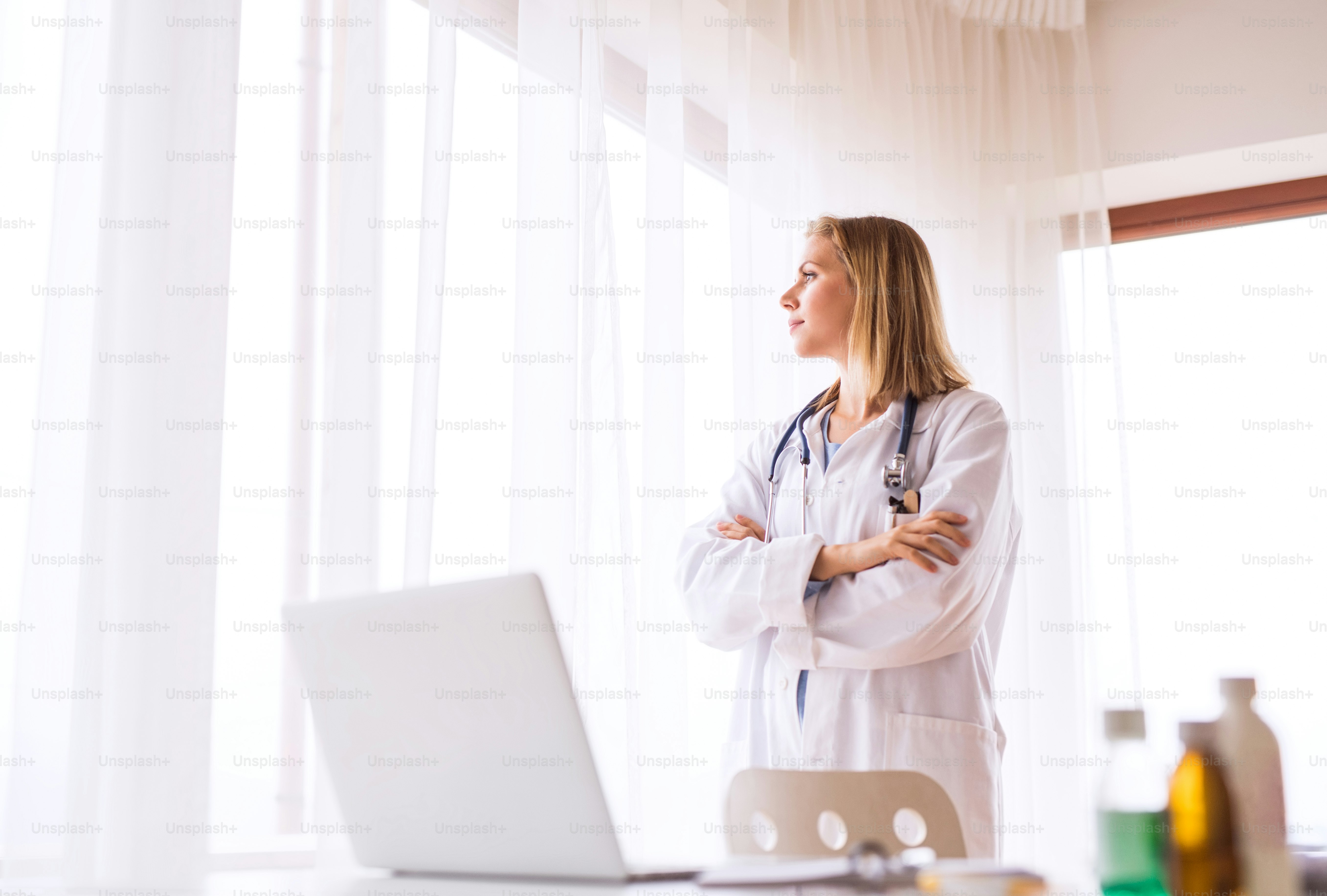 Portrait of a beautiful young female doctor, arms crossed