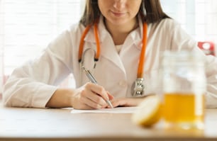 Detail of honey and lemon with doctor woman in background