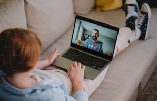 Young woman at home making a video call using tablet, social networks concept.