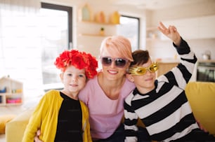 A happy young mother with two children having fun at home.