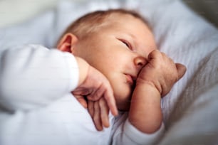 A close-up of a cute sleeping newborn baby at home.