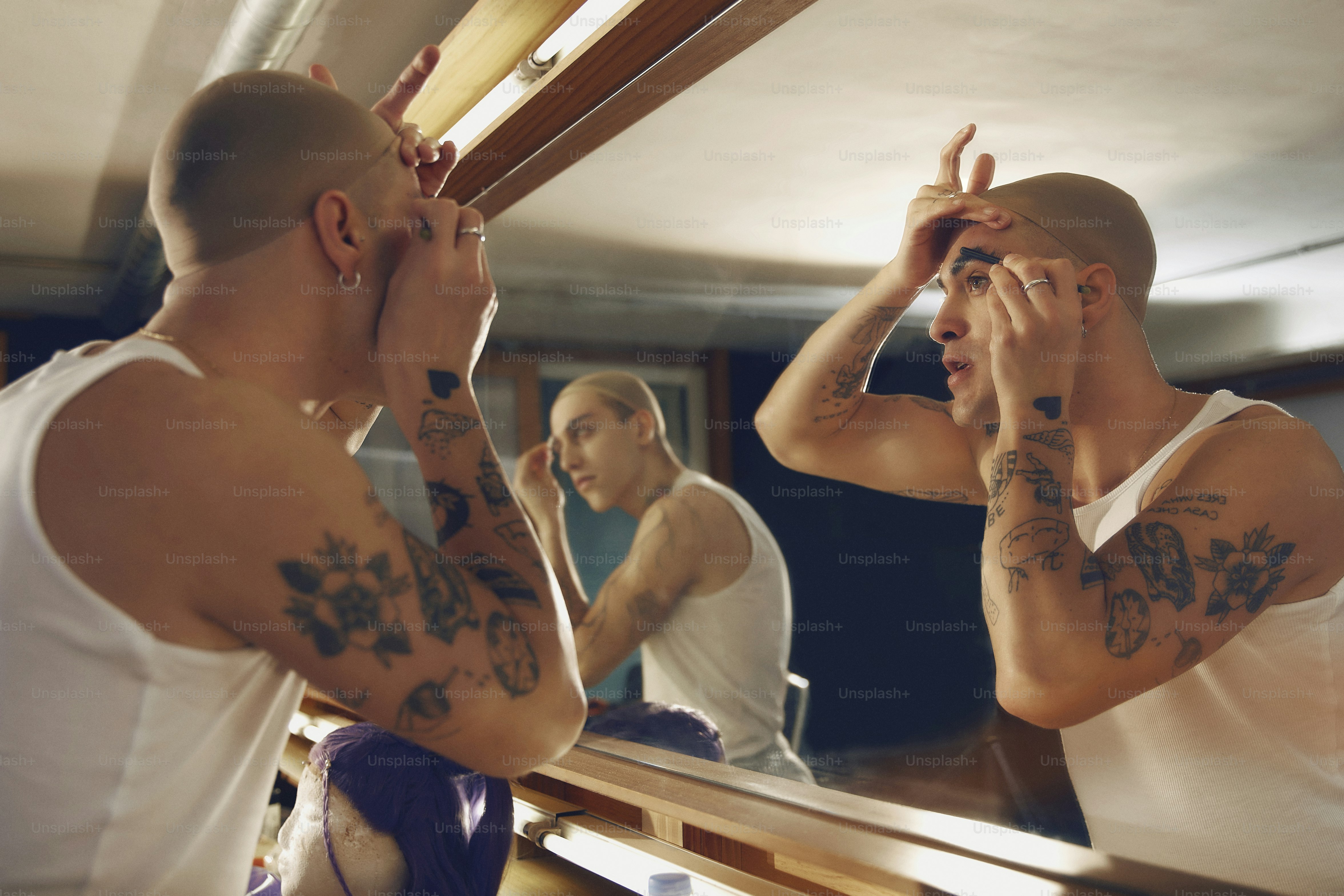 a man looking at himself in the mirror