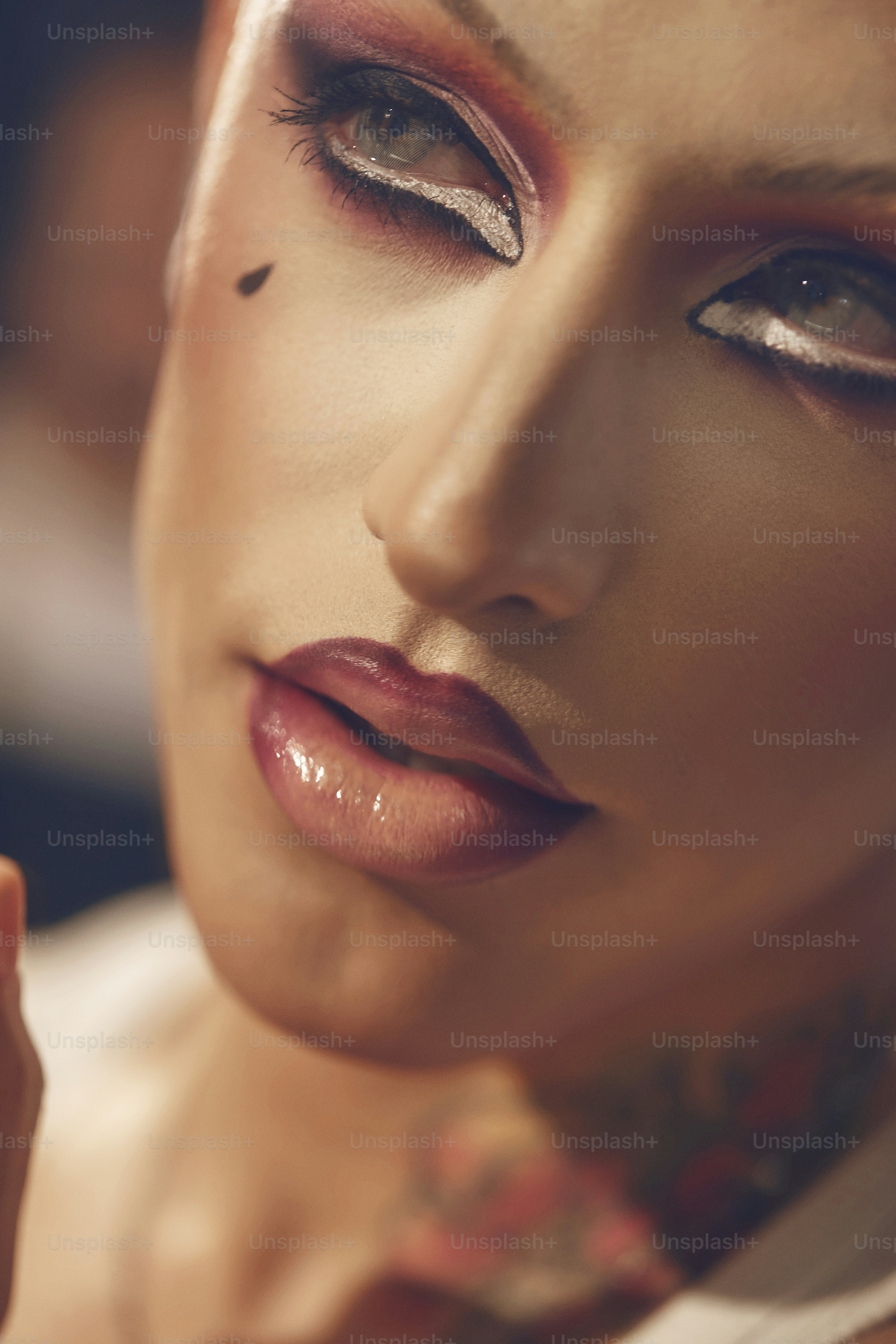 a close up of a woman with tattoos on her face