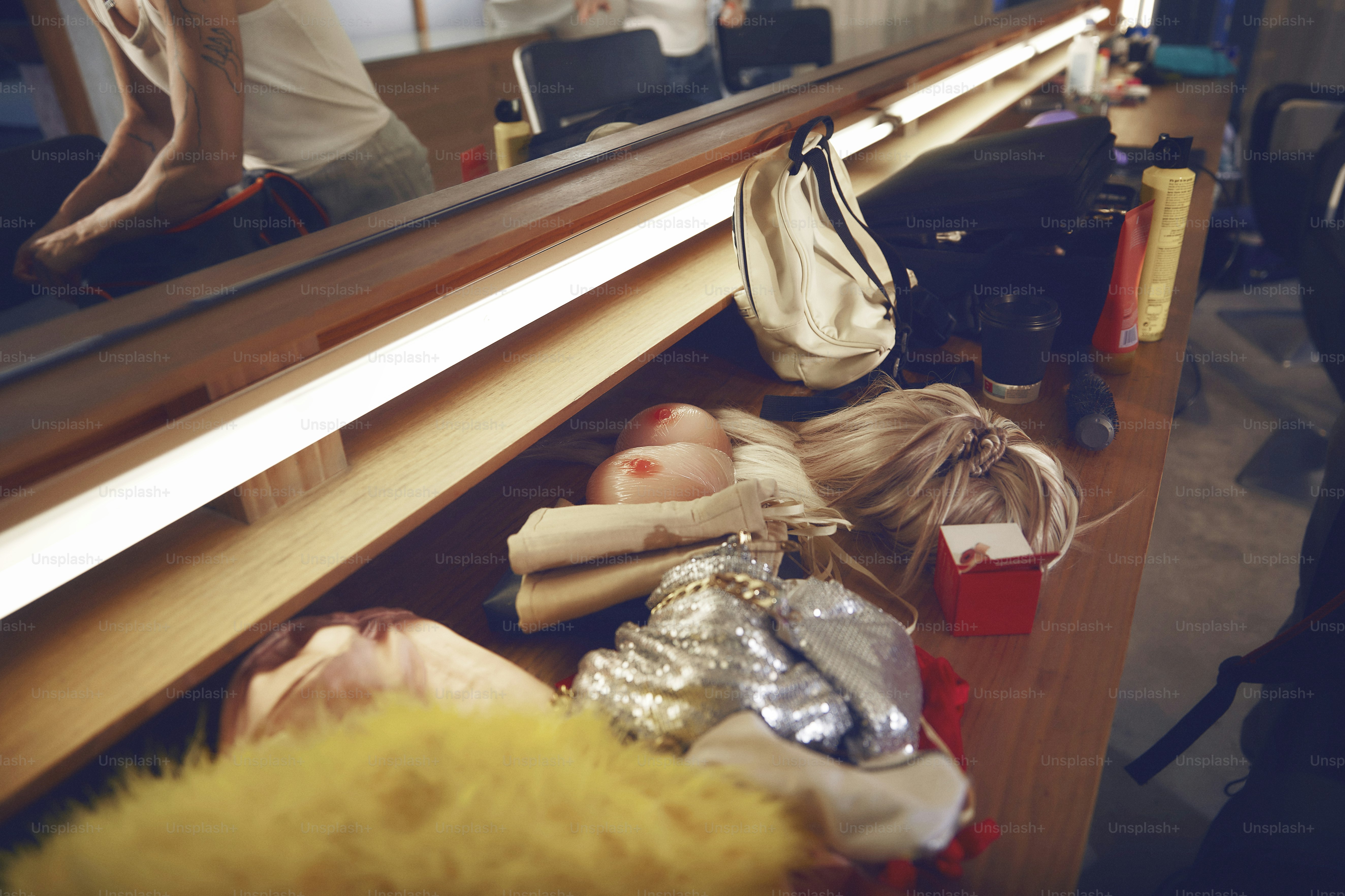 a woman's reflection is in the mirror of a dresser