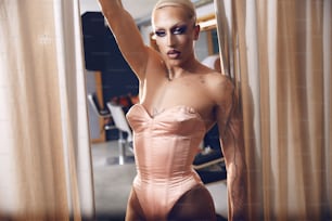 a woman in a pink bodysuit posing for a picture