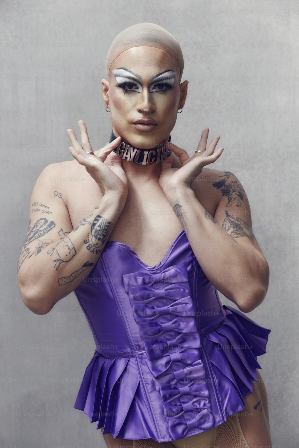 a woman in a purple corset with tattoos