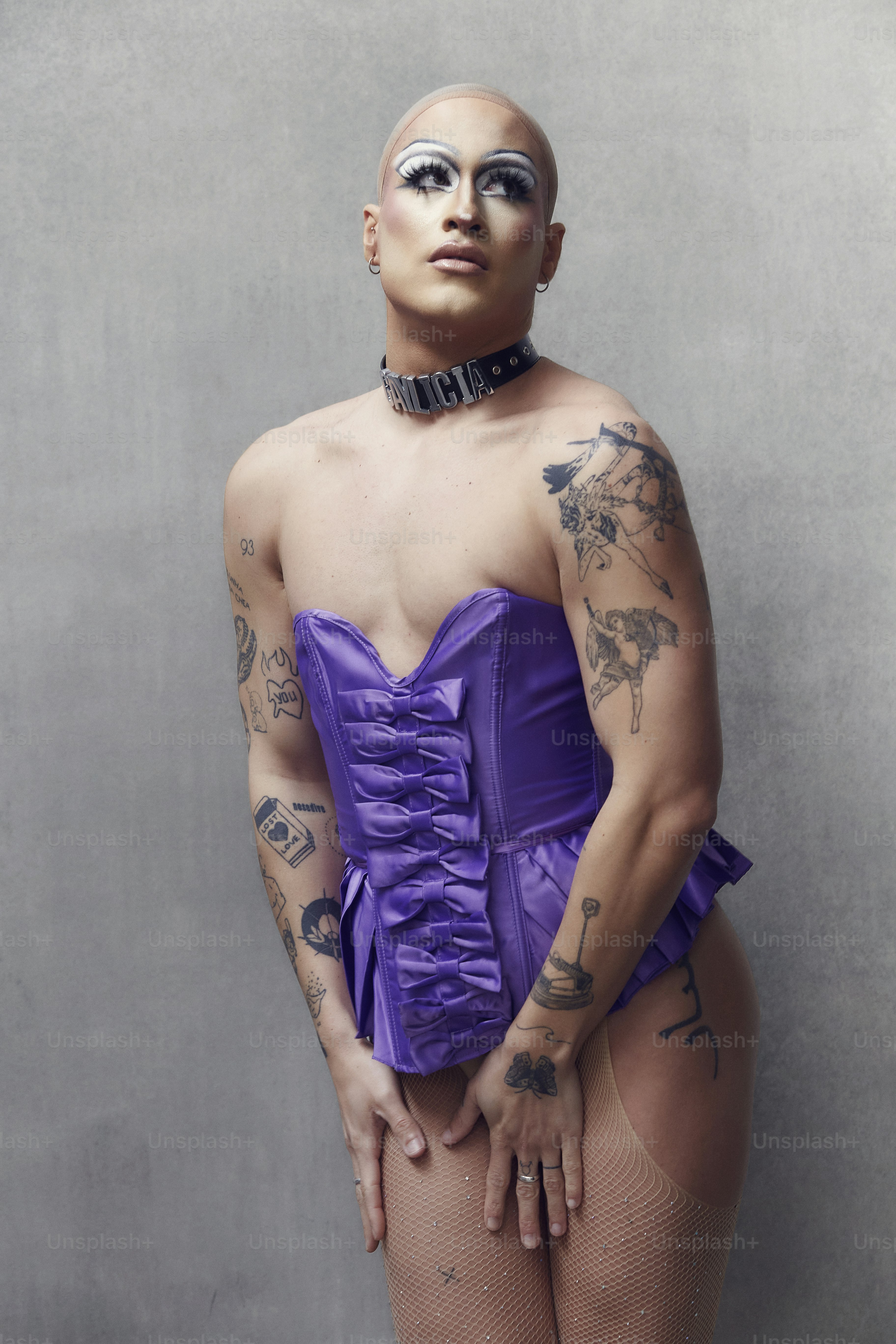a woman in a purple corset poses for a picture