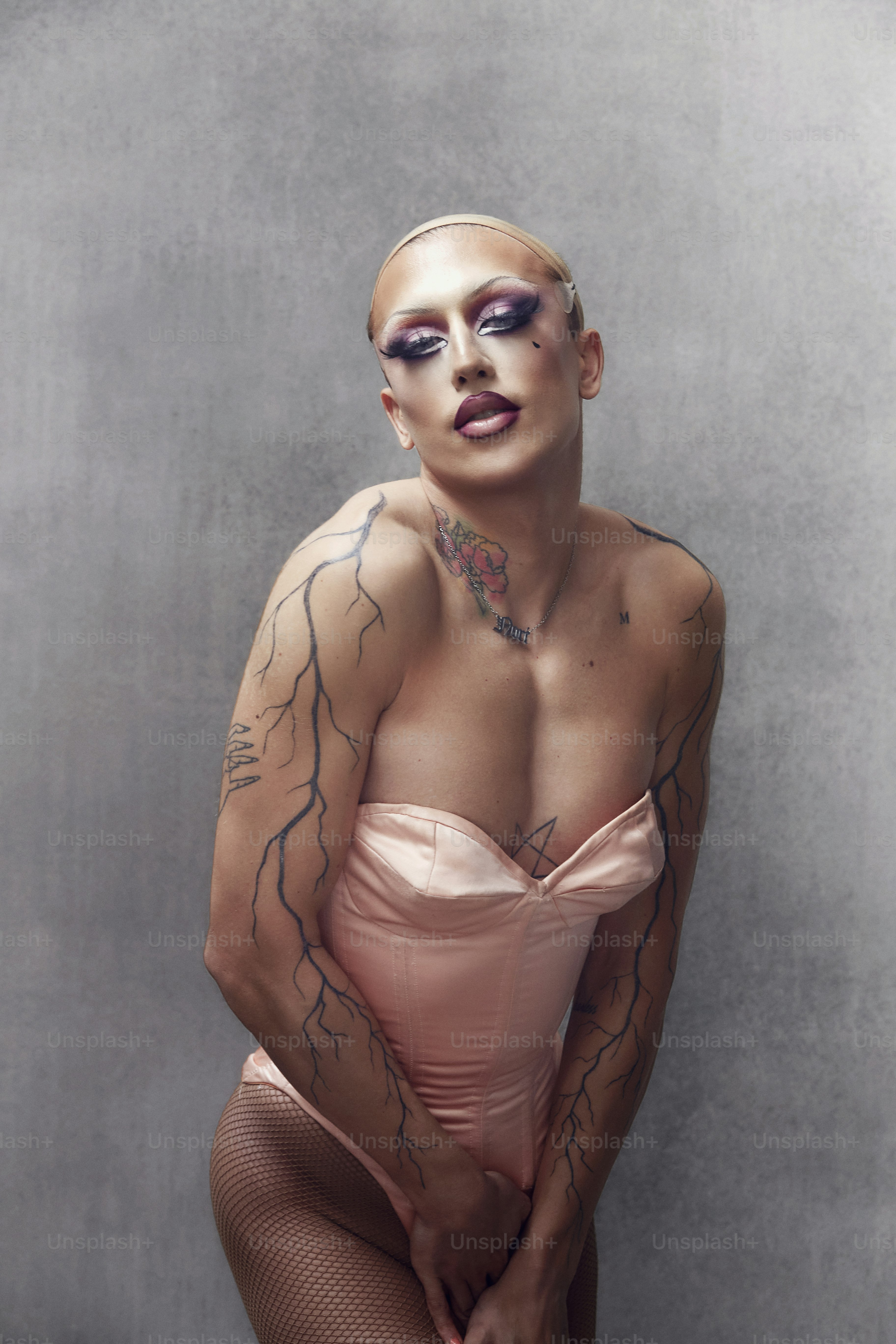 a woman with tattoos on her body posing for a picture