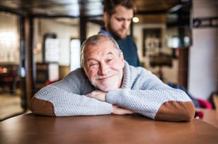 Happy senior father and his young son in a pub.