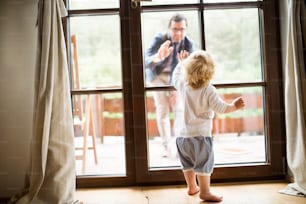 Young father leaving home and bow out with son.