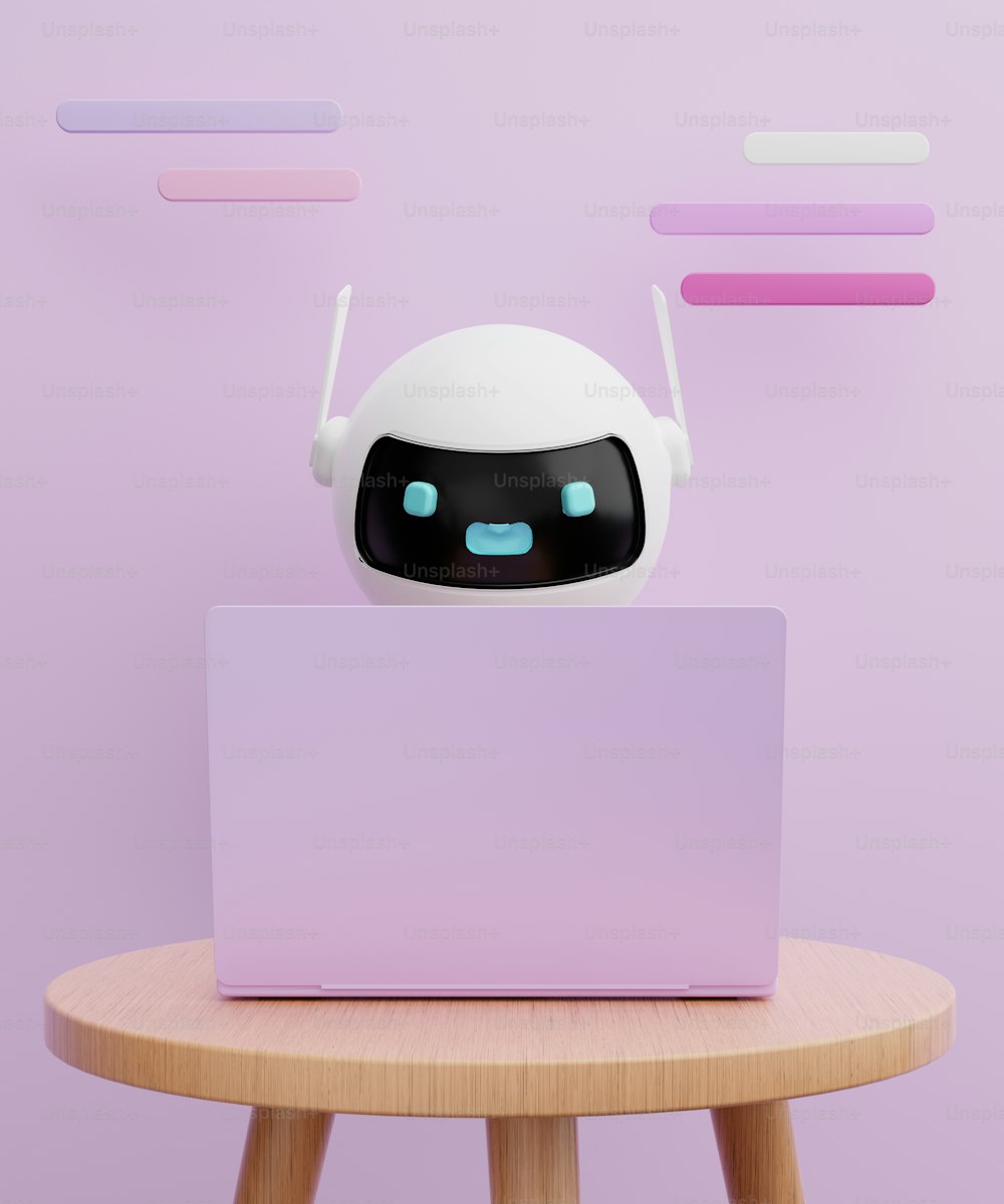 a white robot sitting on top of a laptop computer