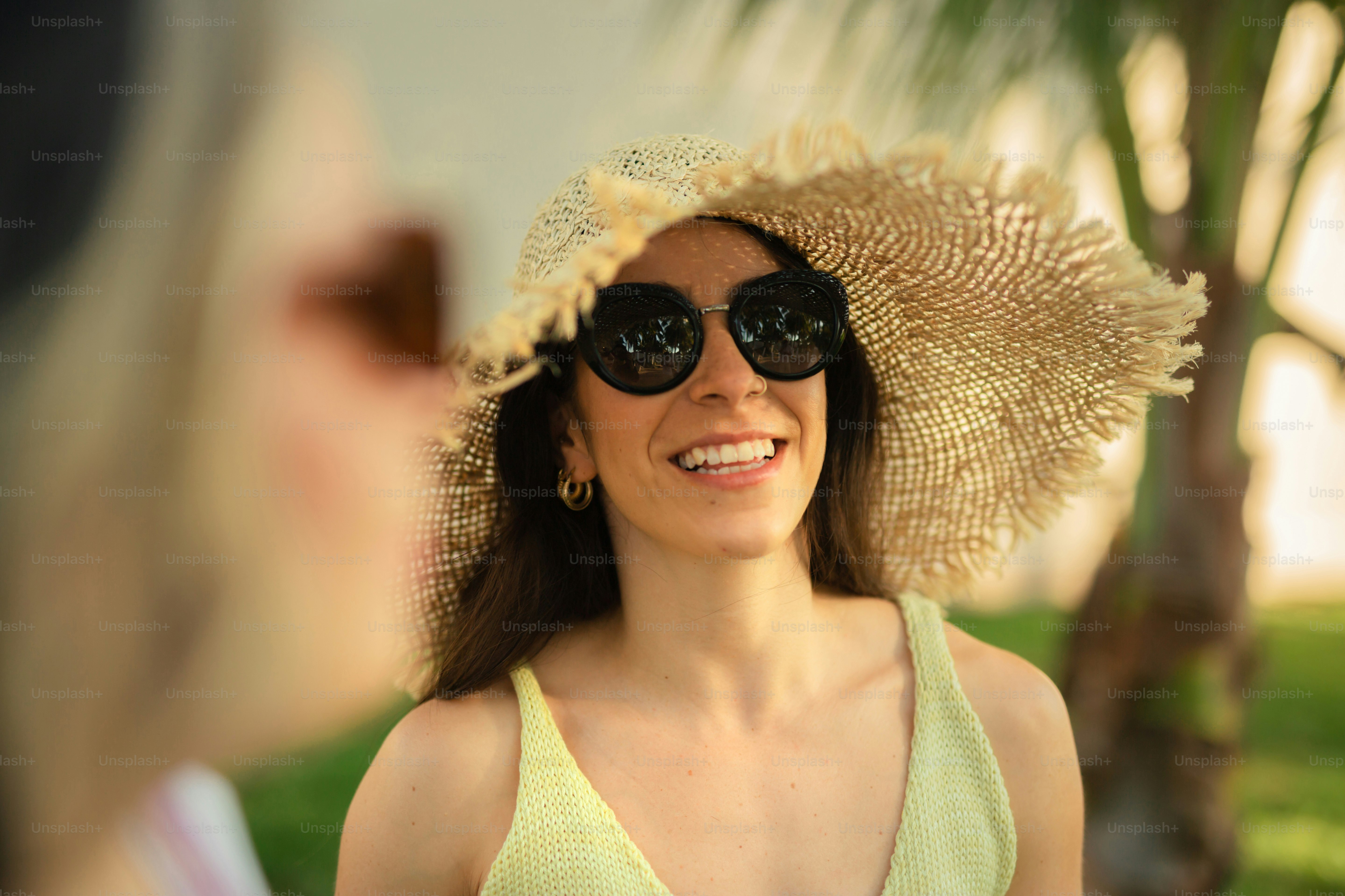 A woman wearing a sun hat and sunglasses photo – Woman in hat Image on ...