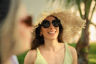 a woman wearing a sun hat and sunglasses