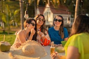 a group of women sitting at a table with drinks