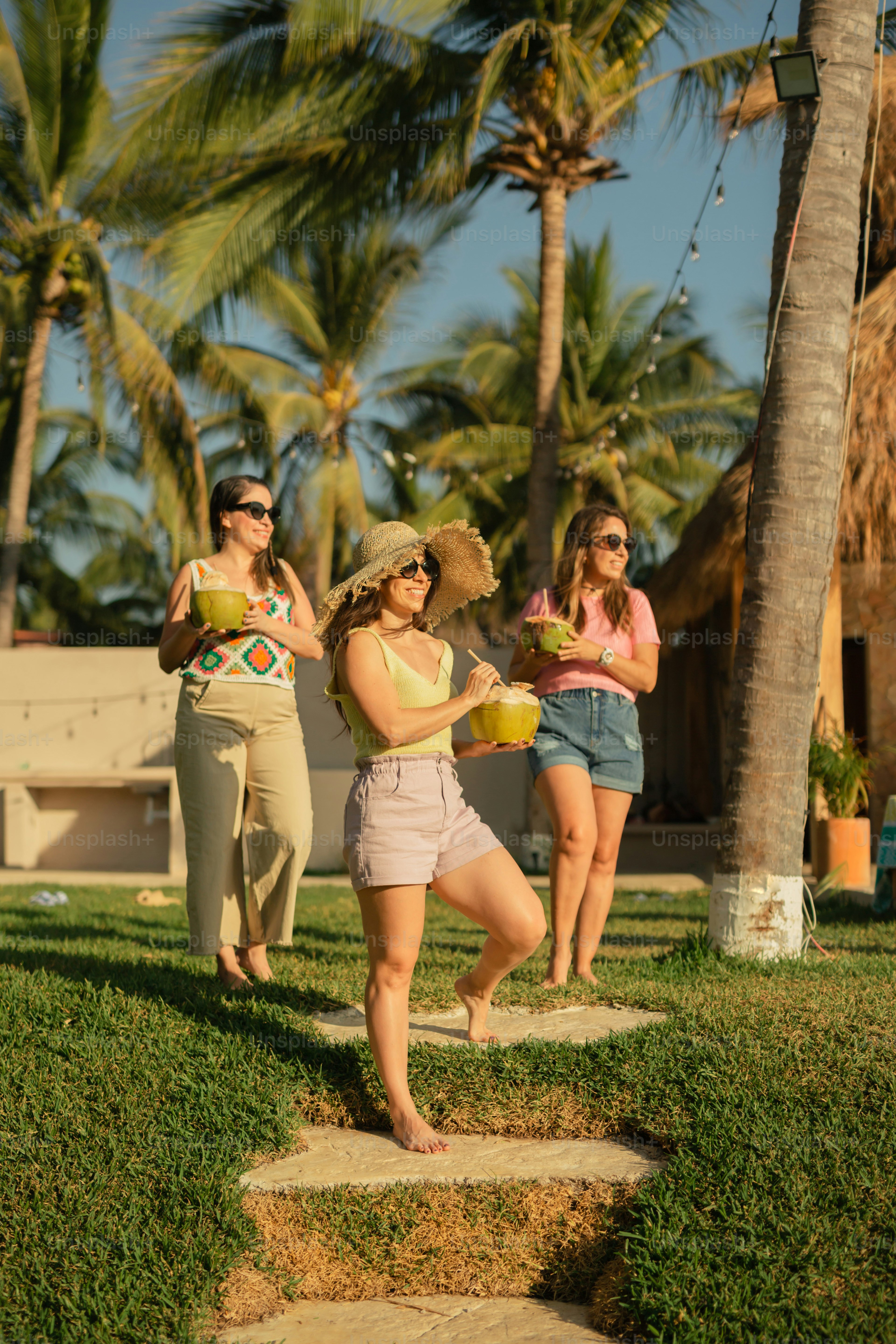 a group of women standing on top of a lush green field