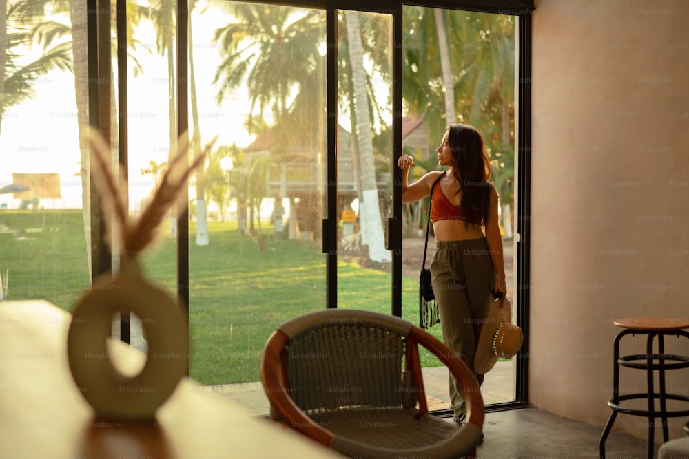 a woman standing in front of a sliding glass door