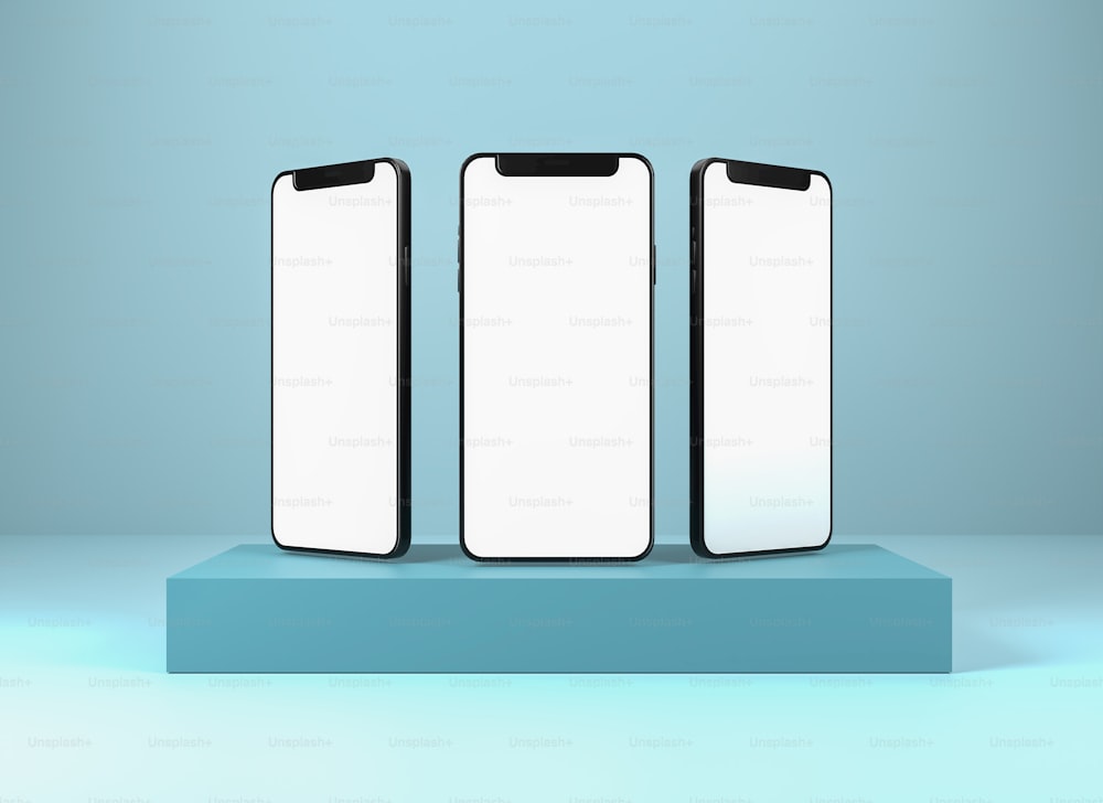 Tres teléfonos celulares sentados encima de una plataforma azul