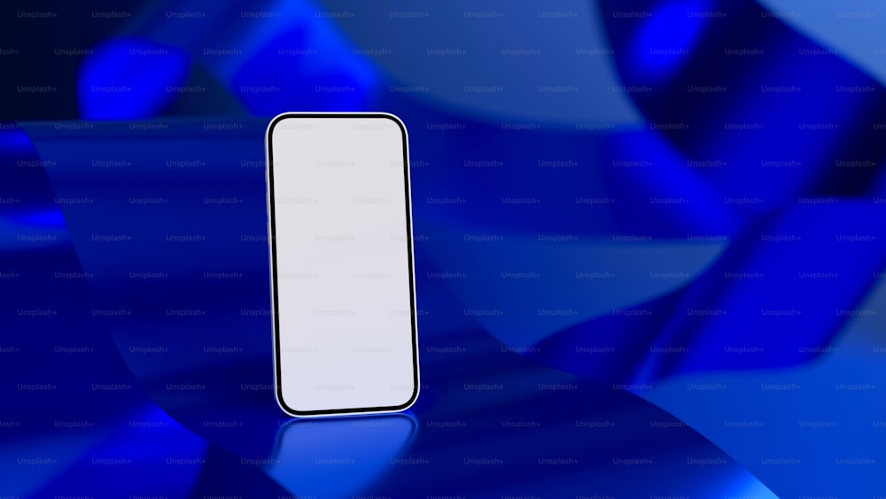 파란색 표면 위에 앉아 있는 흰색 휴대폰