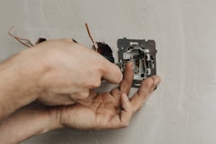a person is trying to fix a light switch