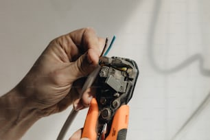 a person holding a pair of pliers in their hands