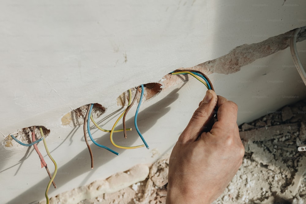 a person is working on electrical wiring in a room