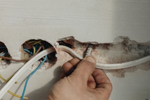 a person is fixing a light switch in a room