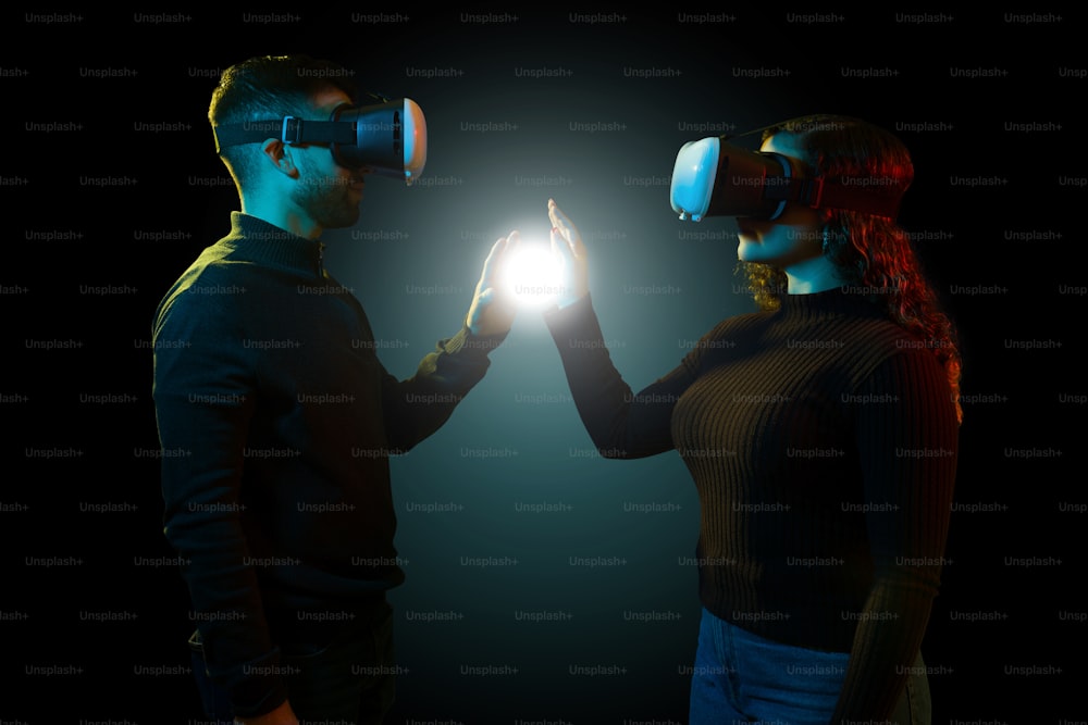 Perfil de una mujer y un hombre jóvenes tocando una luz digital y experimentando una simulación con gafas de realidad virtual
