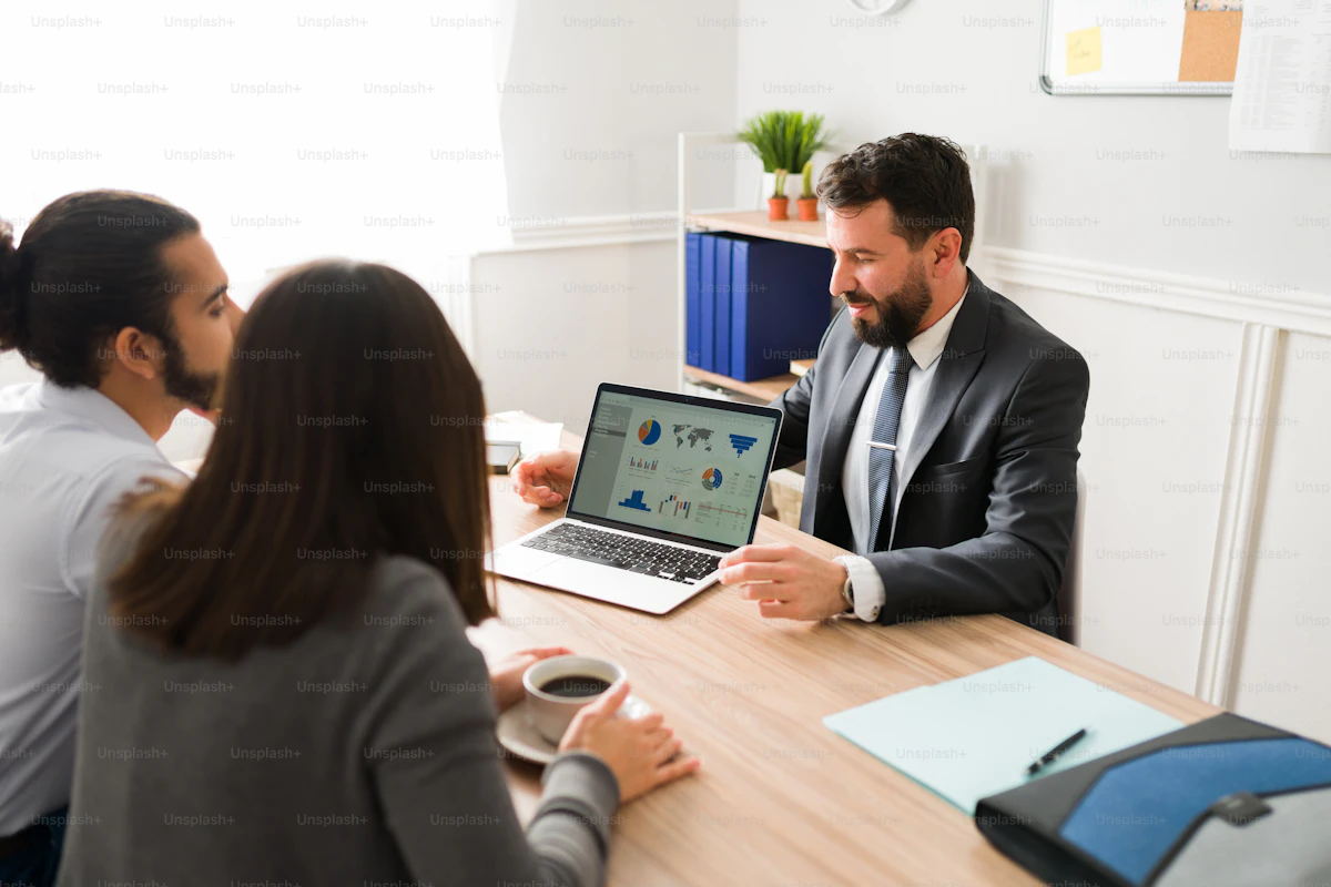 Financial advisor providing personalized consultation to clients in an office setting