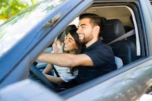 Everything is better together. Beautiful couple hugging and enjoying a road trip in the car