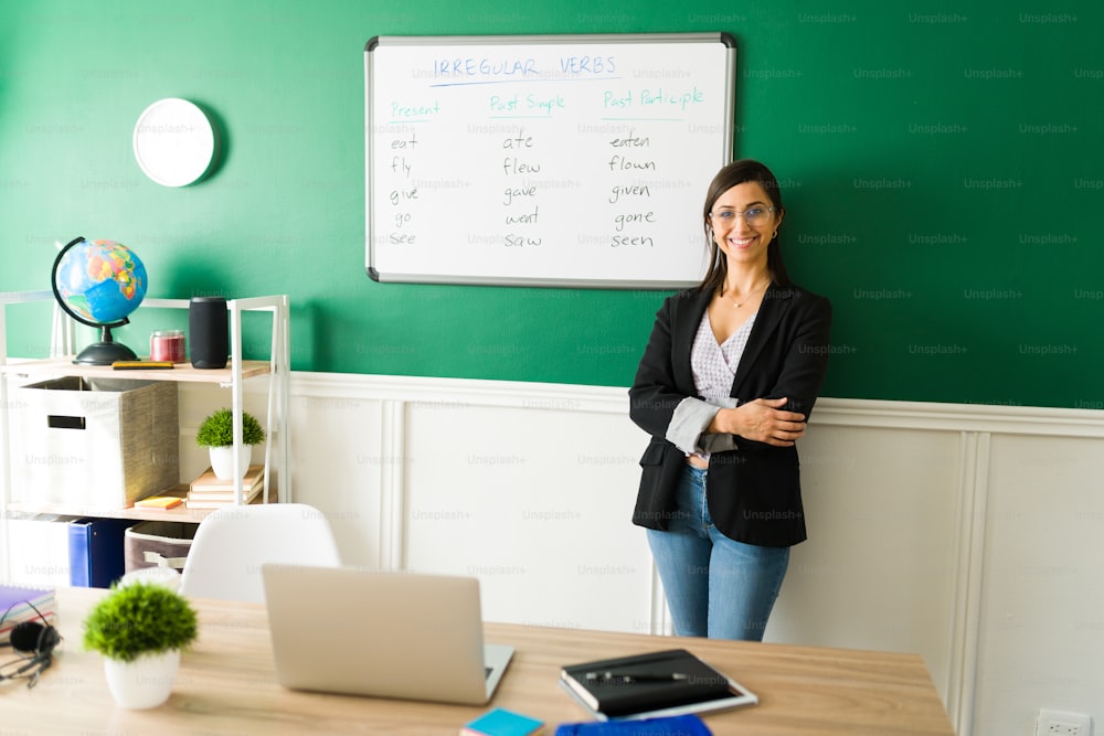 Female teacher smiling and feeling happy while giving a English class. Cheerful woman ready for a virtual lesson from home