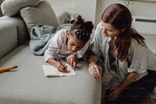 a woman and a little girl sitting on a couch