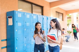 High school friends talking in corridor at university