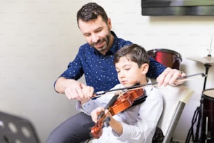 Latin instructor developing kid's musical talent in violin school
