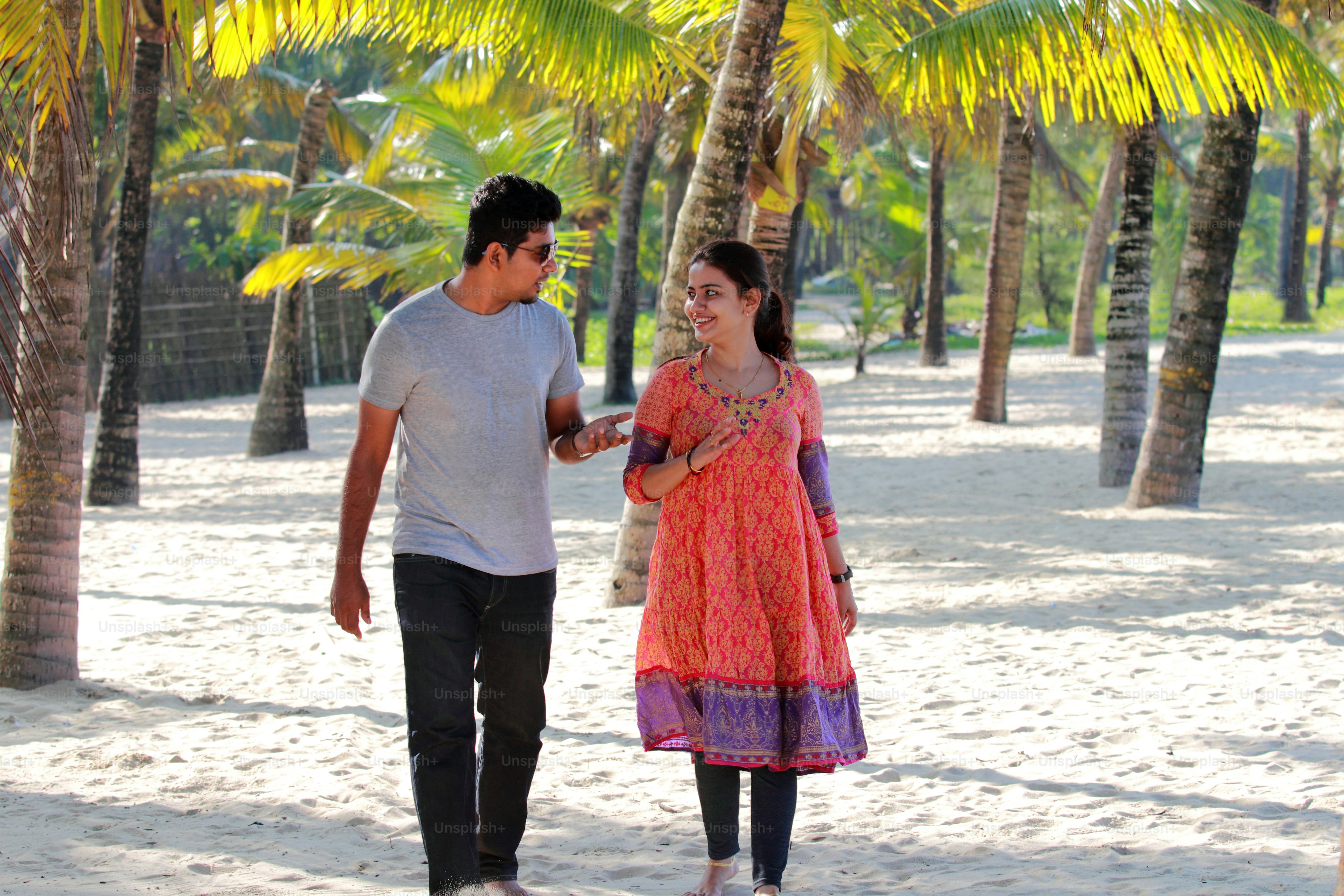 Romantic young couple walking in the beach