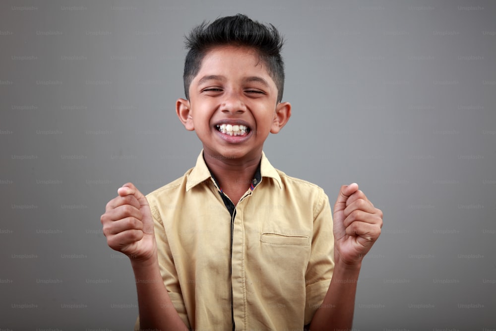 Portrait of a cheering boy of Indian origin