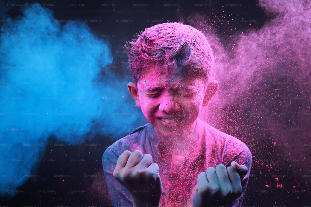 Little boy plays with colours. Concepts for Indian festival Holi