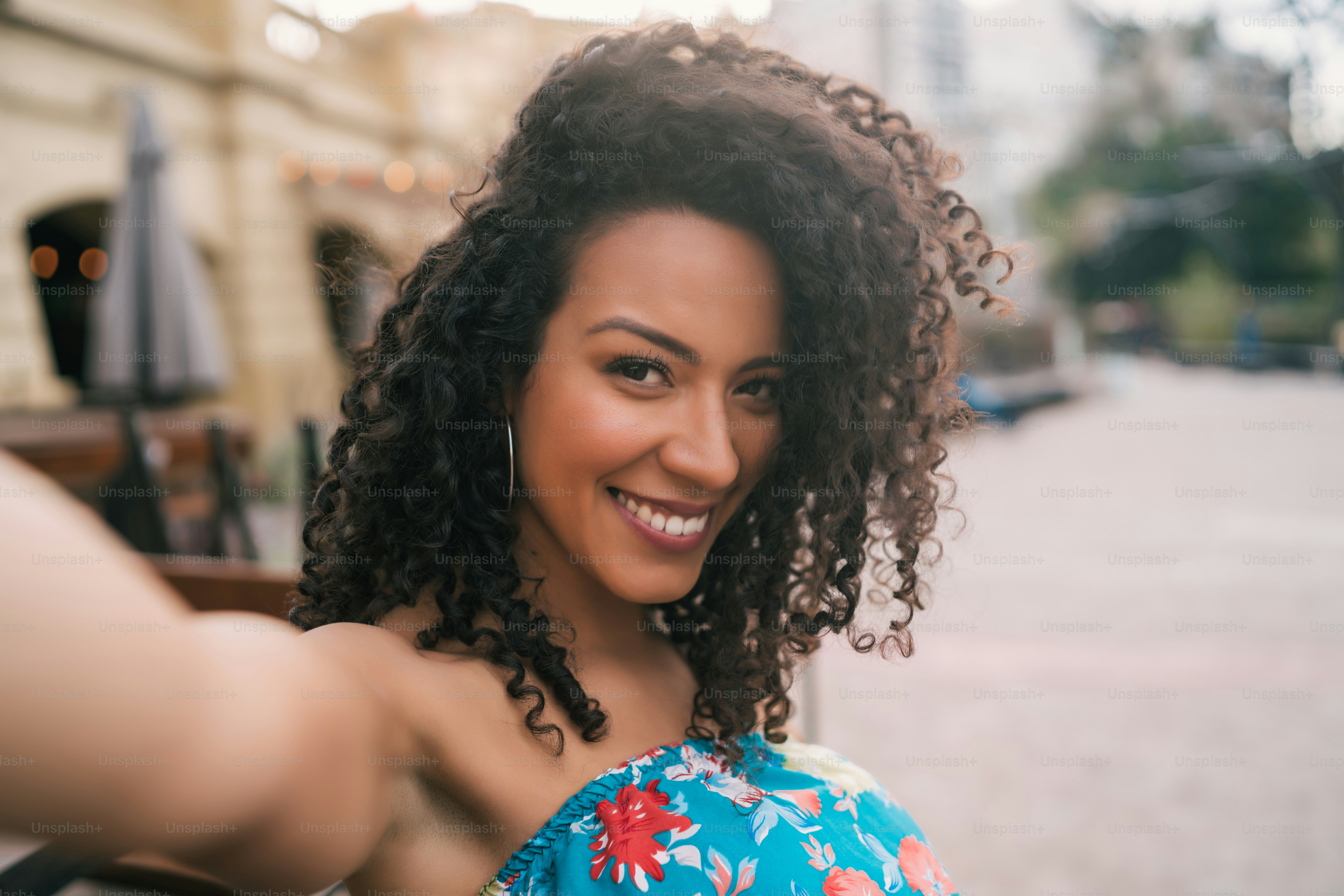 Portrait of young afro american woman taking a selfie outdoors in the street. Enjoying life. Lifestyle concept.