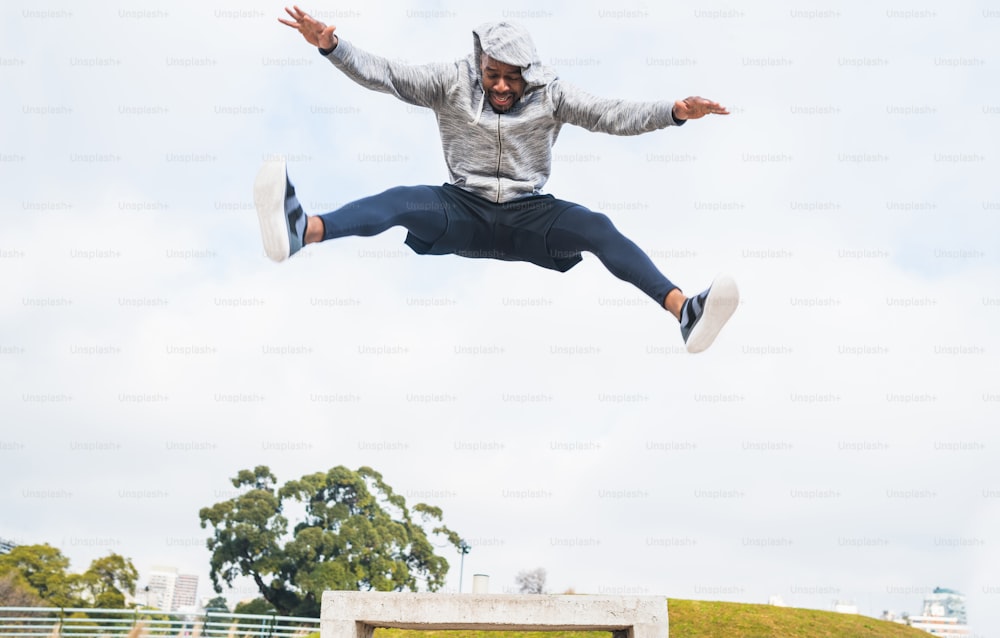 Portrait of a sport man jumping and doing exercise outdoors. Sport, fitness and healthy lifestyle.