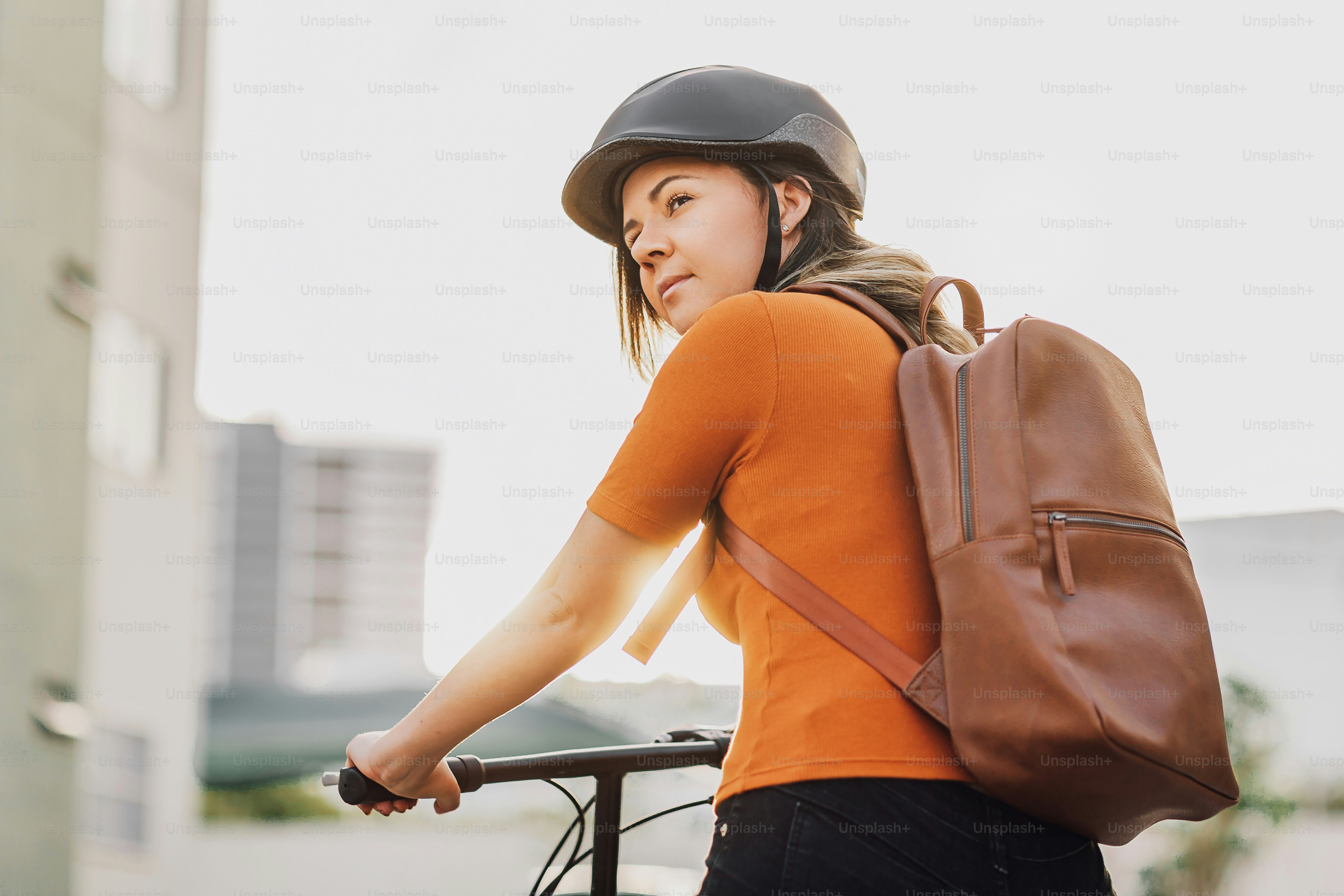 Young woman riding a bicycle through the city